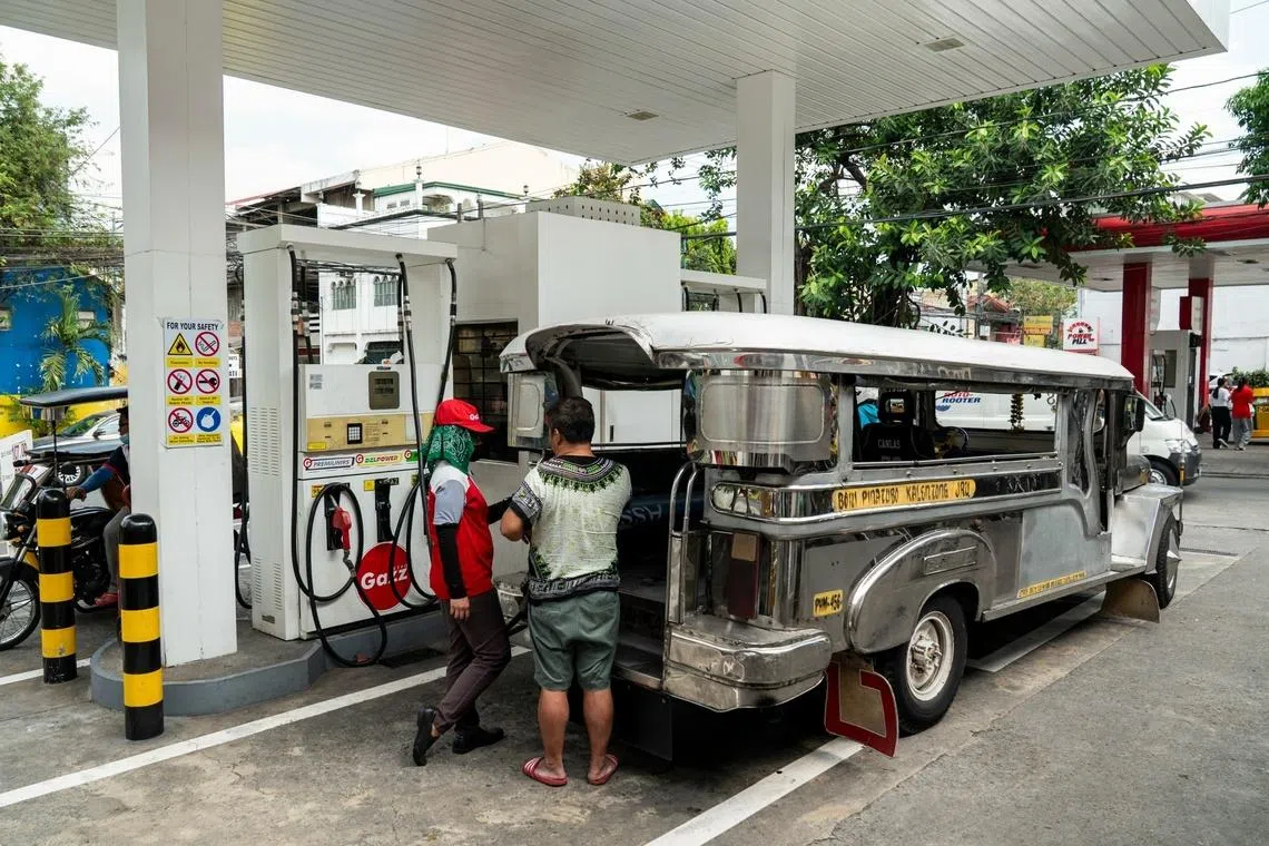 A jeepney driver refuels at a gas station in Mandaluyong in the Philippines. Photographer: Lisa Marie David/Bloomberg