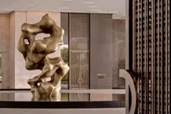 The hotel entrance features a sculpture by Zhang Xian titled Two Forms.