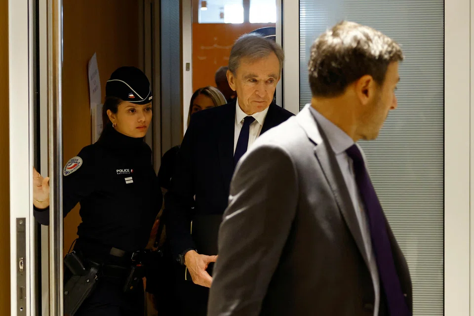 Bernard Arnault (centre), chairman and chief executive officer of LVMH, leaves after a hearing to testify in the trial of France's former spy chief Bernard Squarcini, at the courthouse in Paris.