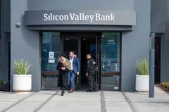 Customers exiting Silicon Valley Bank headquarters in Santa Clara, California on March 13.  The lender's technology startup clients and investors fled last week, spurring the second-biggest bank failure in US history.