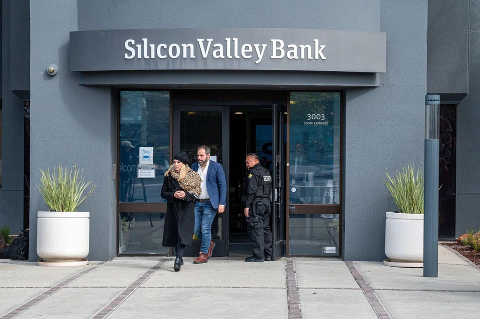 Customers exiting Silicon Valley Bank headquarters in Santa Clara, California on March 13.  The lender's technology startup clients and investors fled last week, spurring the second-biggest bank failure in US history.
