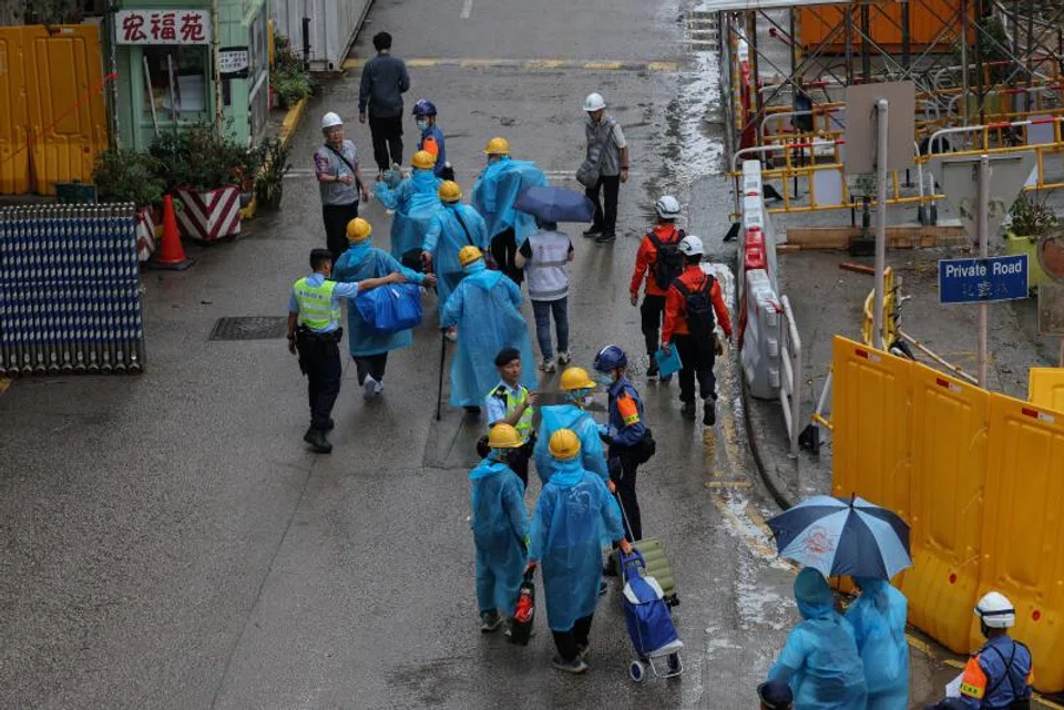 270 former residents wearing facemasks, helmets and gloves for protection returned to the complex on Monday accompanied by firemen.