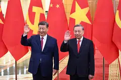 Vietnam's Communist Party General Secretary To Lam and China's President Xi Jinping wave during a meeting at the office of the Party Central Committee in Hanoi on Apr 14.