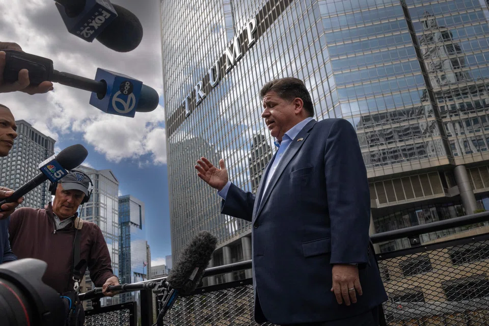 Illinois Governor JB Pritzker speaks with reporters on the Chicago water taxi as they pass Trump International Hotel and Tower in Chicago, Illinois, Aug 25, 2025. Pritzker warned President Donald Trump to keep the military out of Chicago and reminded his audience that of the 10 states with the highest homicide rates, eight are led by Republican governors. 