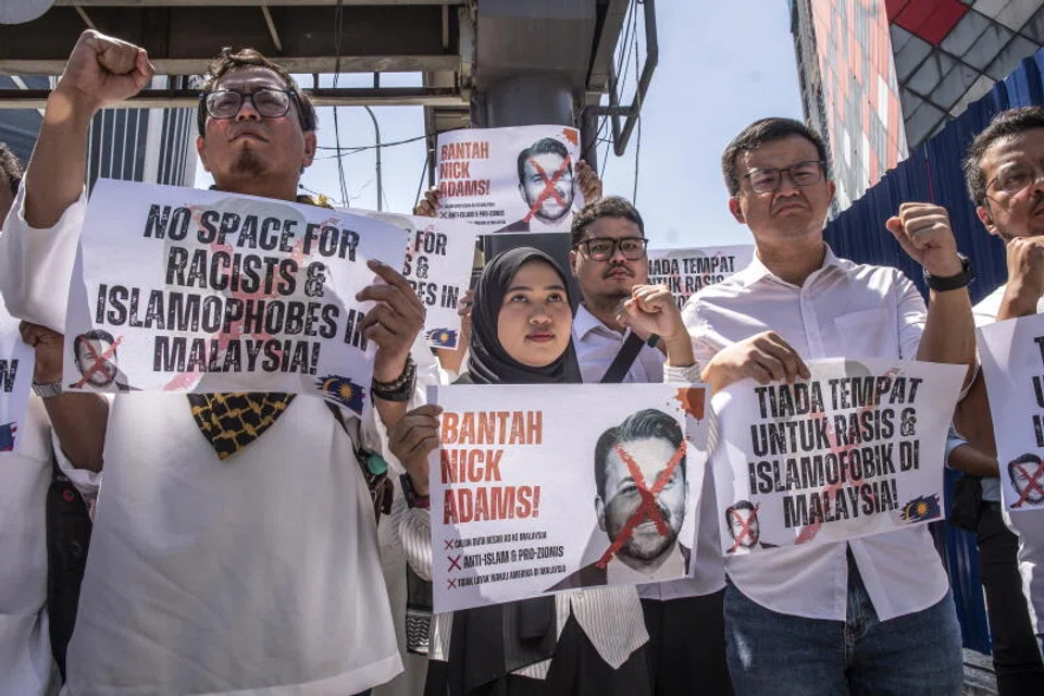 Activists hold placards depicting Trump's nominee for US ambassador to Malaysia, Nick Adams, during a protest outside the US Embassy in Kuala Lumpur.