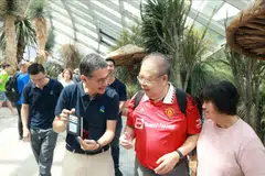 Patrick Lee, chief executive of Singapore and Asean at StanChart (left)  with 74-year-old beneficiary Tee Nam Sang (centre) and his wife Chong Yong Lian at Flower Dome on Friday where the seniors put their new skills to the test.