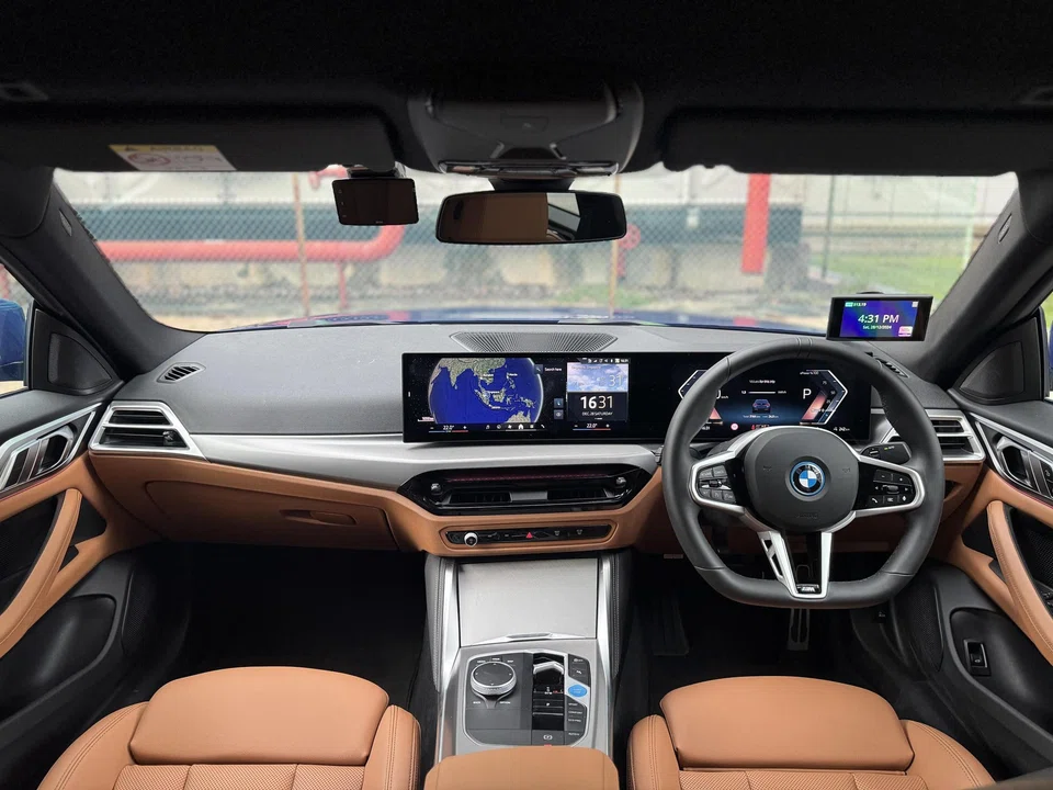 The i4 feels like a car with sporty intentions from behind the wheel.