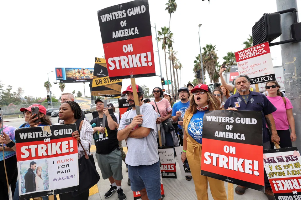 SAG-AFTRA actors and Writers Guild of America (WGA) writers walk the picket line during their ongoing strike outside Netflix offices in Los Angeles, California, Sept 22, 2023. 