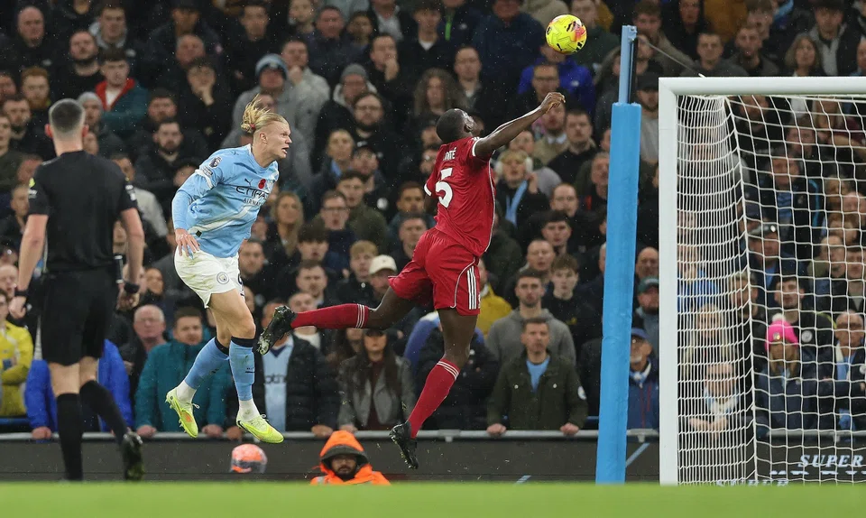 Manchester City's Erling Haaland (left) scores the first goal during the English Premier League match between Manchester City and Liverpool FC, Manchester, Britain, Nov 9, 2025.  