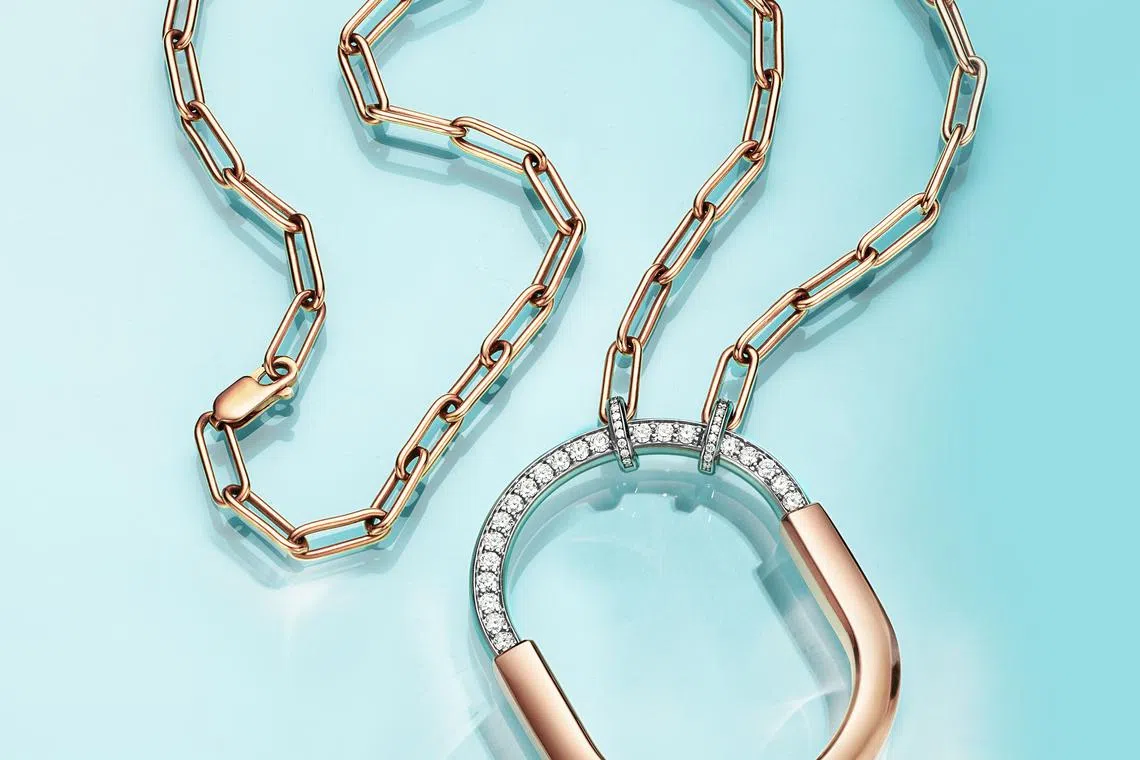Lock by Tiffany pendants feature a striking oval link chain that echoes the padlock motif. Featured here is a Lock pendant in rose and white gold with diamonds. 