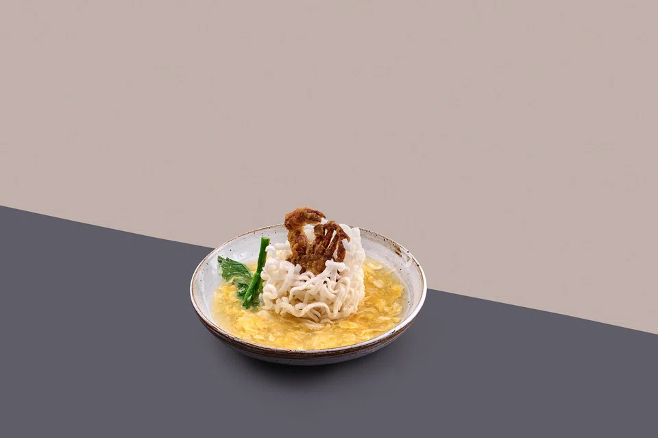 Crispy rice noodles doused in an eggy gravy and topped with soft-shelled crab.