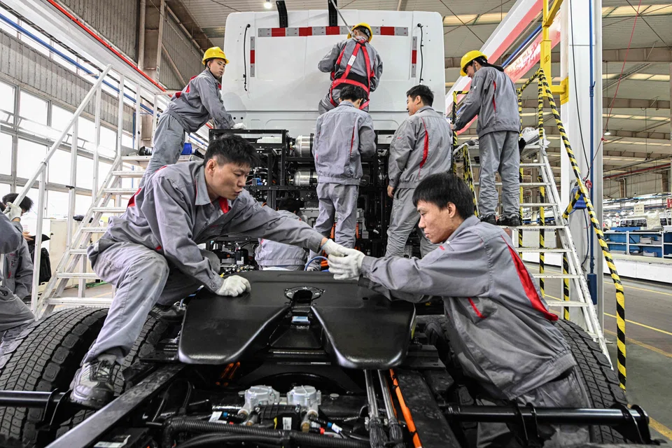 Staff at Chinese electric truck startup Windrose work on an electric truck at a factory in Suzhou, China, Nov 18. 2024. 