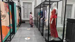 Kebaya designer Oniatta Effendi looking at the different varieties of the kebaya at the Love, Kebaya exhibition at the National Museum of Singapore.