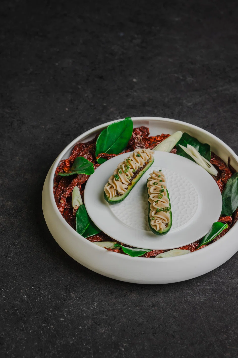 Baby cucumber is stuffed with chilli jam and cashew cream.