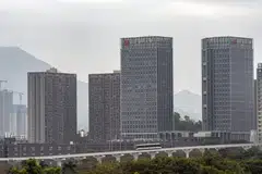 A growing number of young white-collar professionals are trading expensive, cramped quarters in Hong Kong for less pricey and roomier digs in Shenzhen (top).