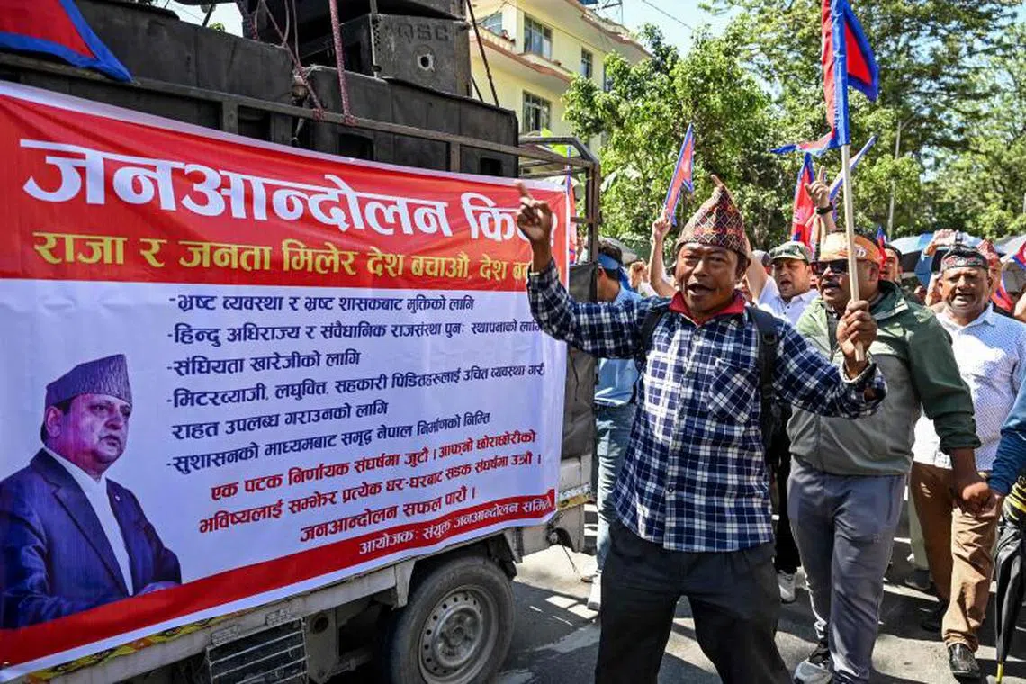A demonstrator carrying Nepal's national flag shouts slogans as he takes part in a pro-monarchy rally in Kathmandu.