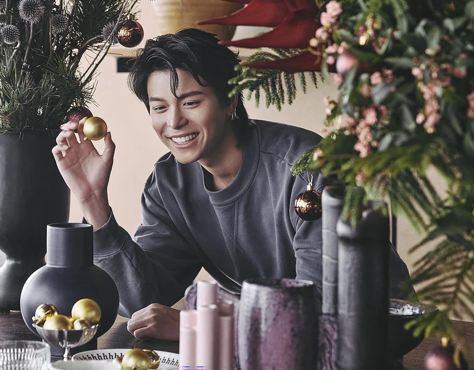 Glenn Yong wears a washed indigo sweatshirt by Coach.