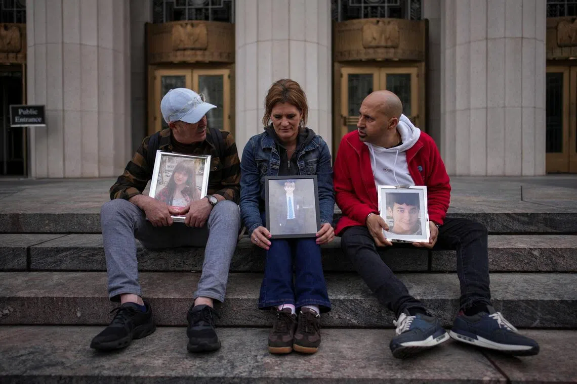 (From left) Mariano Janin, Ellen Roome, and George Nicolaou sit outside a court with photos of their children who died, during a trial in a key test case accusing Meta and Google's YouTube of harming children's mental health through addictive platforms, Los Angeles, California, Feb 11, 2026. 