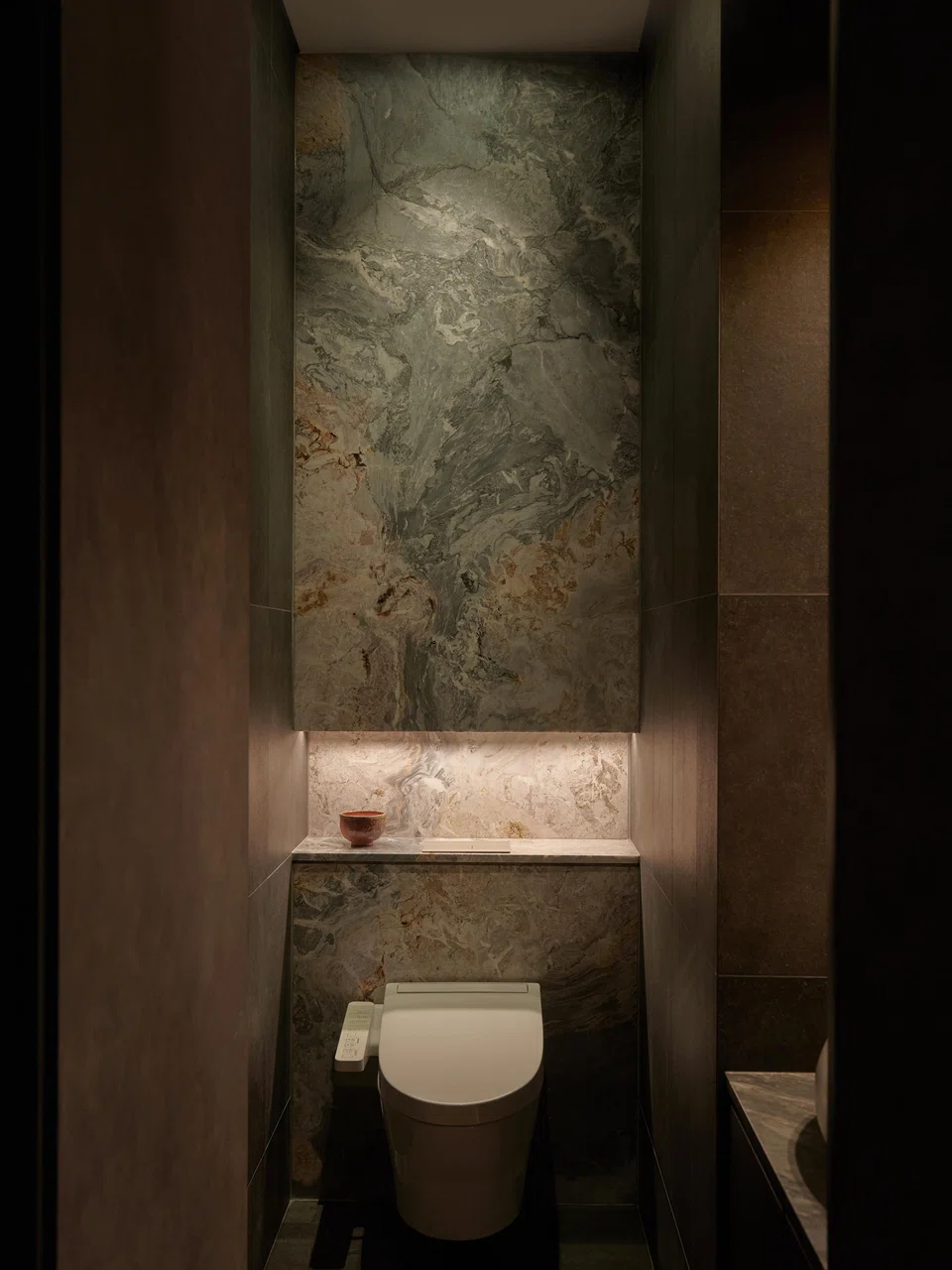 Patterned marble accents the powder room.
