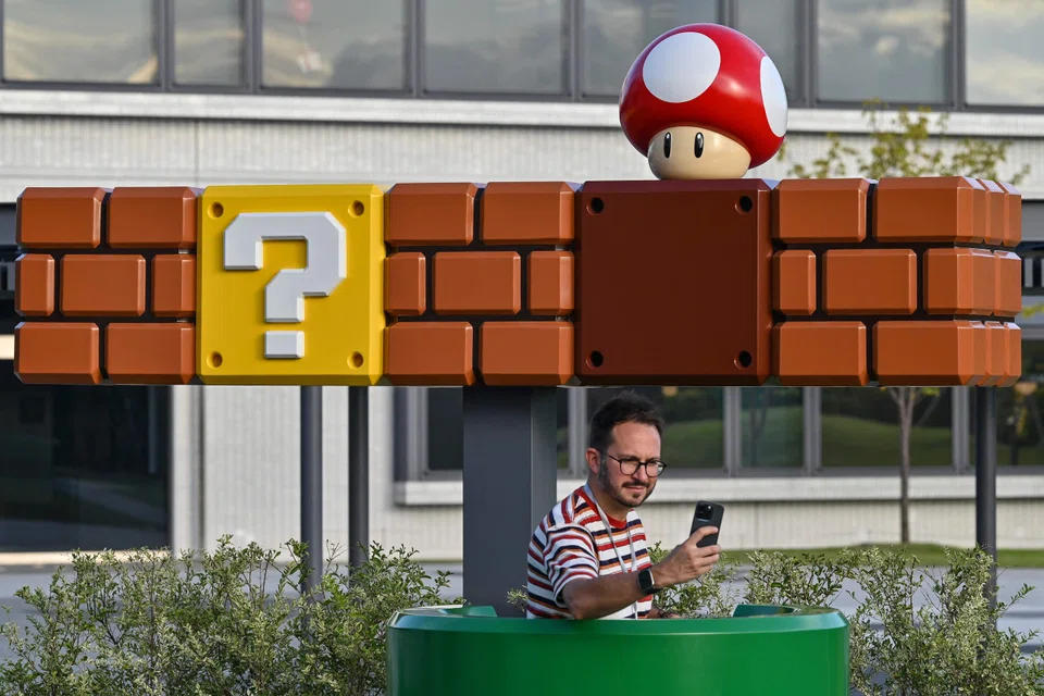 A visitor taking a selfie in the courtyard at the new Nintendo Museum in Kyoto. Japan, Sept 24, 2024.