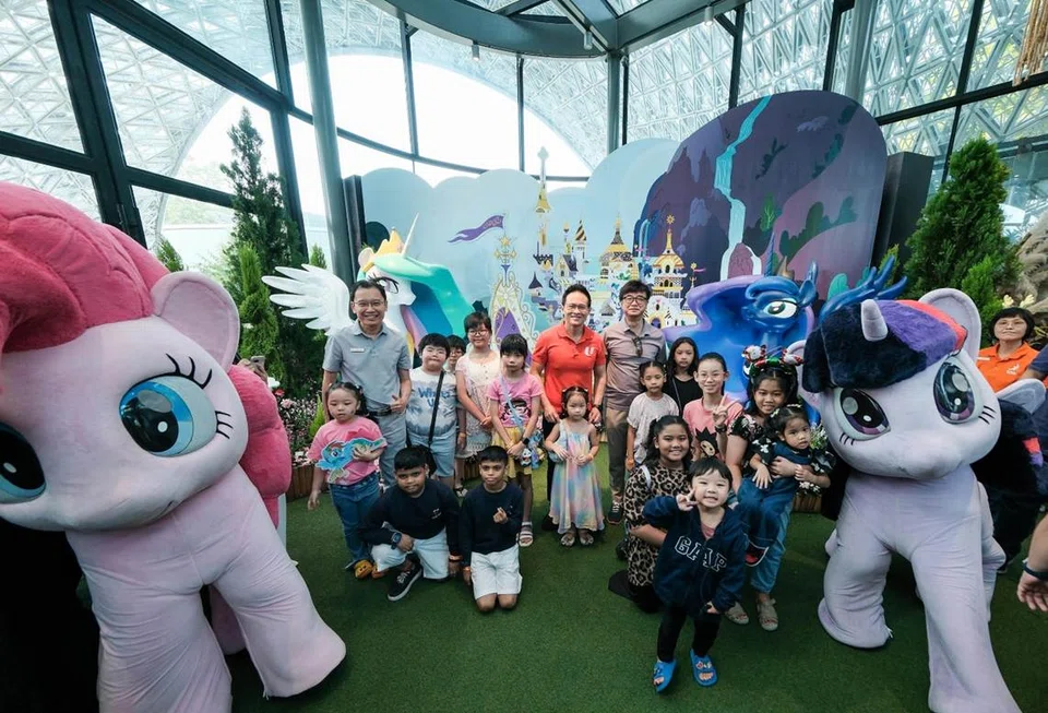 Gardens by the Bay CEO Felix Loh (left, in grey) and NTUC deputy secretary-general Desmond Choo (centre, in red) at the launch of My Little Pony: Petals of Friendship at Floral Fantasy.
