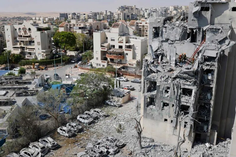 Emergency workers check the damage caused to a building from an Iranian missile strike in Beersheba in southern Israel. The Israeli military has accused Tehran of violating a ceasefire announced earlier.