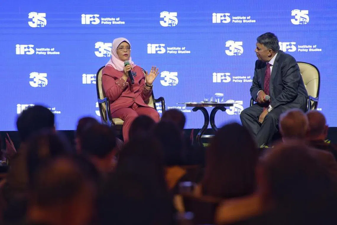 Existing structures must be examined to see how effective they still are in integrating new migrants, said President Halimah Yacob. With her is dialogue moderator Patrick Daniel.