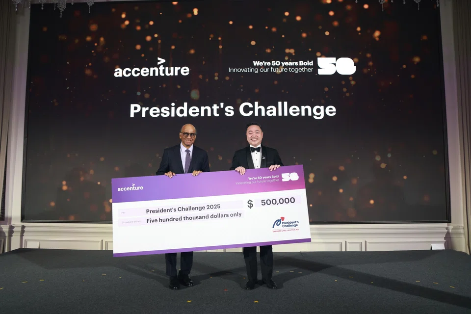 President Tharman Shanmugaratnam (left) and Mark Tham, country managing director of Accenture Singapore, at the company's 50th anniversary dinner. Accenture has announced that it will donate S$500,000 to the President's Challenge.