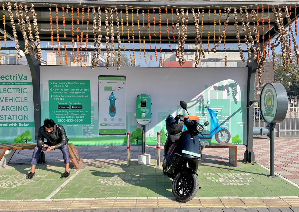 An Ola electric scooter being charged at an electric vehicle charging station in New Delhi, India, Feb 12, 2022. India has made significant investments in clean energy, adding more than 100 gigawatts of capacity in the last 10 years. 