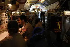 Crew and scientists of Nasa's DC-8 airborne science laboratory work inside the aircraft and readings taken from the aircraft can help improve the interpretation of satellite data, and lead to more accurate models. 