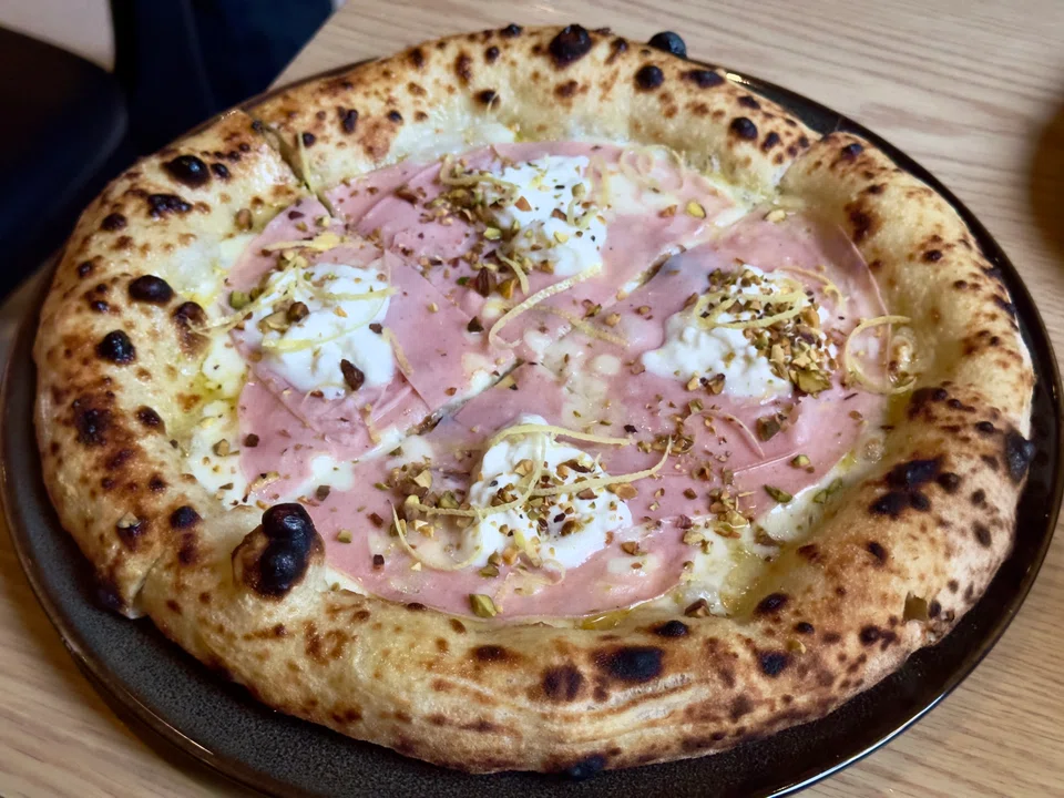 Mortazza pizza is topped with mortadella sausage and creamy stracciatella cheese.