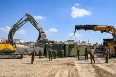 Members of the Israeli army building a bomb shelter for residents of the Arara Bedouin community in Israel's southern Negev Desert, on Oct 14. 
