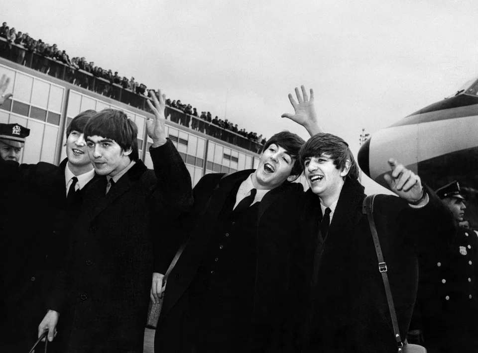 The Beatles -- from left to right, John Lennon, Ringo Starr, Paul McCartney and George Harrison -- arriving at John F Kennedy Airport in New York, United States, where they were greeted by a large crowd on Feb 7, 1964.