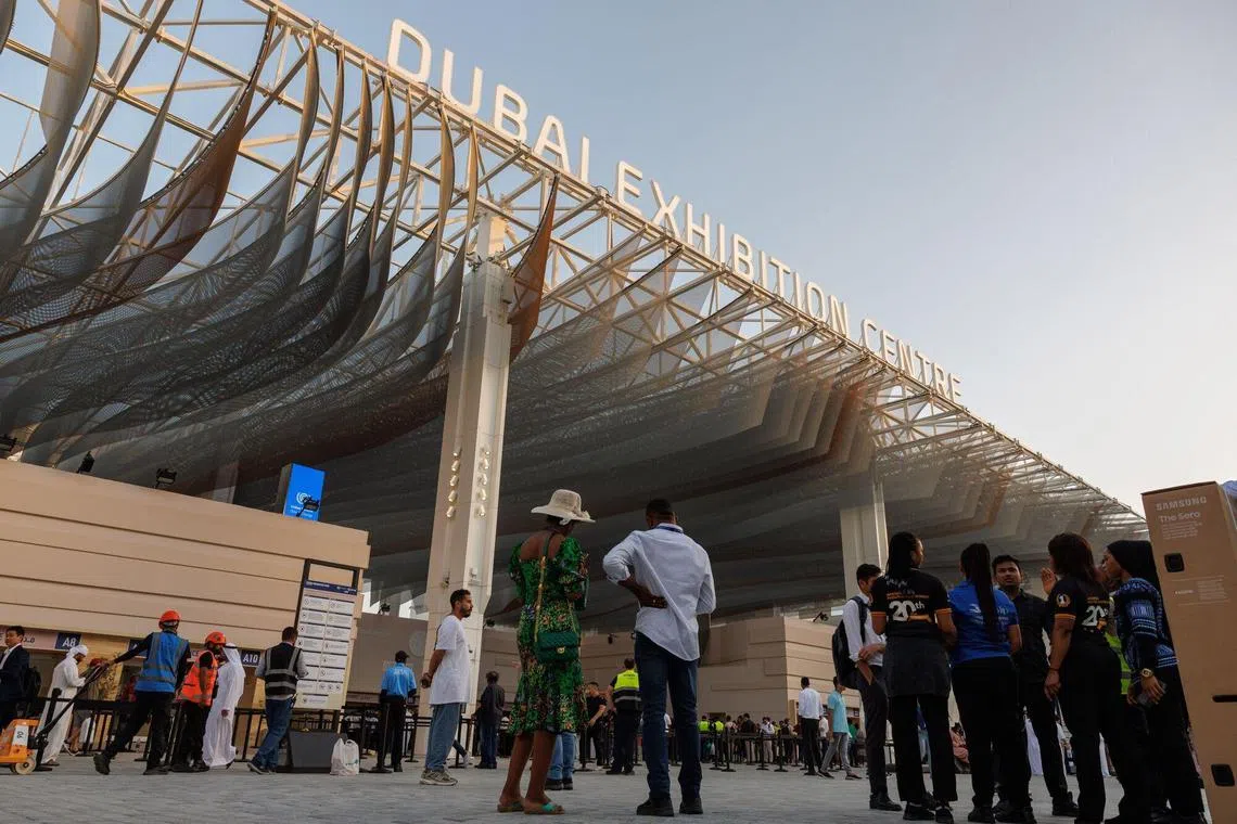 Attendees outside the entrance to the Blue Zone ahead of the COP28 climate conference at Expo City in Dubai, United Arab Emirates, on Nov 29, 2023. More than 70,000 politicians, diplomats, campaigners, financiers and business leaders are in  Dubai to talk about arresting the world's slide toward environmental catastrophe. 