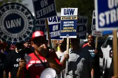 Supporters and members of the United Auto Workers union- Local 230 march along a picket line during a strike outside of the Stellantis Chrysler Los Angeles Parts Distribution Centre in Ontario, California, Sept 26, 2023. 