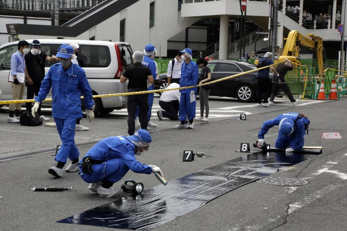 Police officers at the scene where Former Japanese Prime Minister Shinzo Abe was shot during a political event in Nara, Japan, on July 8, 2022. 