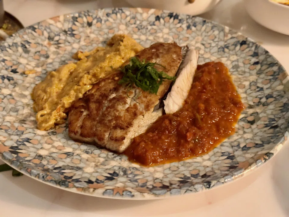 Grilled sea bass is paired with a duo of chickpea and red pepper sauces.