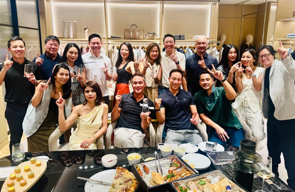 Team Boss golfers holding up their second runner-up trophies at a gathering to celebrate the BT Golf League. Seated are (from left) former captain Marilyn Lum, current vice-captain John Lim, current captain Andre Huber and managing director Steven Lam.
