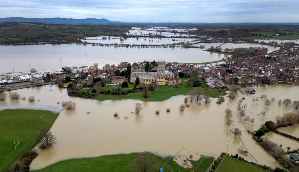 Floodwater from the rivers Avon and Severn surrounds Tewkesbury Abbey in the aftermath of Storm Henk in Tewkesbury, Britain, Jan 8, 2024. Increased flooding from overflowing rivers and blocked drains is causing insurers to pull back from offering coverage, particularly for commercial properties and residential landlords, according to industry representatives.