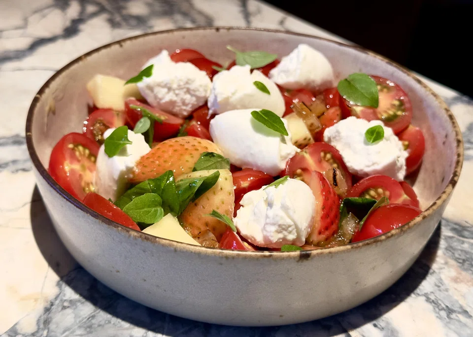 A refreshing cherry tomato and strawberry salad.