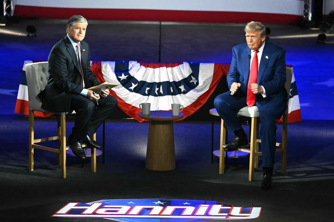 Republican presidential candidate Donald Trump (right) at a town hall moderated by Fox News broadcaster Sean Hannity in Pennsylvania, on Sep 4. 