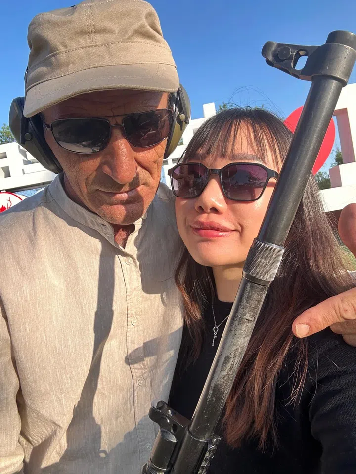 Hong with her shooting coach in Kazakhstan.