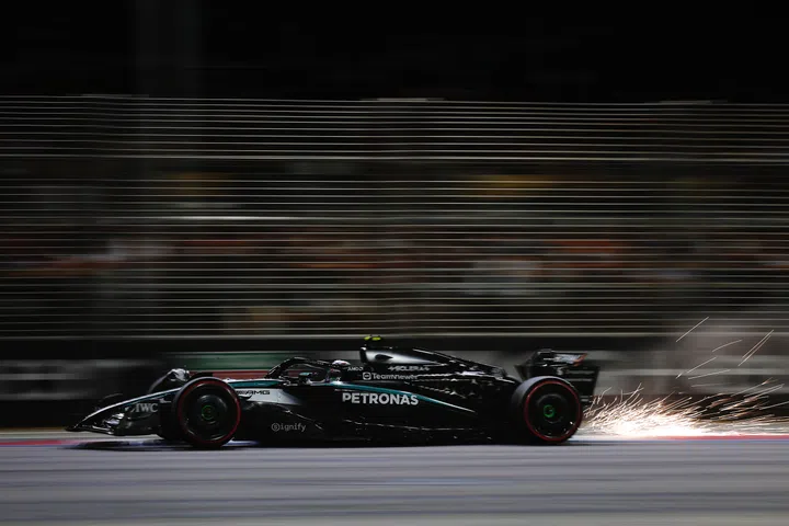 SINGAPORE, SINGAPORE - OCTOBER 04: Sparks fly behind Andrea Kimi Antonelli of Italy driving the (12) Mercedes AMG Petronas F1 Team W16 on track during qualifying ahead of the F1 Grand Prix of Singapore at Marina Bay Street Circuit on October 04, 2025 in Singapore, Singapore. (Photo by Glenn Dunbar/LAT Images)