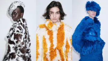 Models on the Bottega Veneta Fall Winter 2026 runway showcasing oversized shaggy faux fur coats in electric blue, orange-white patterns, and spotted brown-white textures with matching textured headwear.