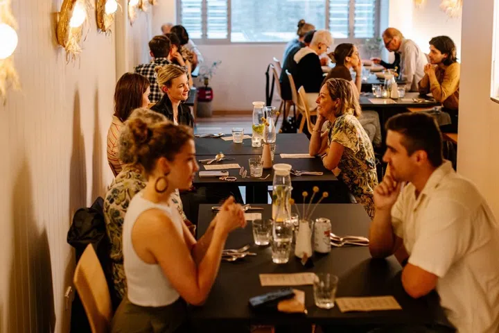 Paying guests at a Refettorio OzHarvest pay-it-forward meal.