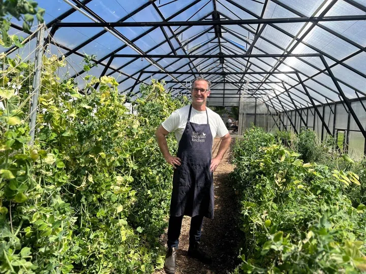 Agrarian Kitchen’s Rodney Dunn in the restaurant’s lush greenhouse.
