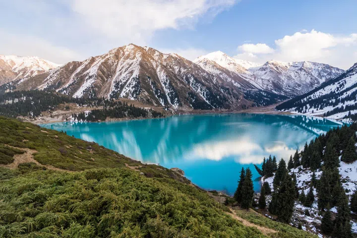 A scenic view of the Big Almaty Lake with Tianshan Mountains in Kazakhstan near the city of Almaty.