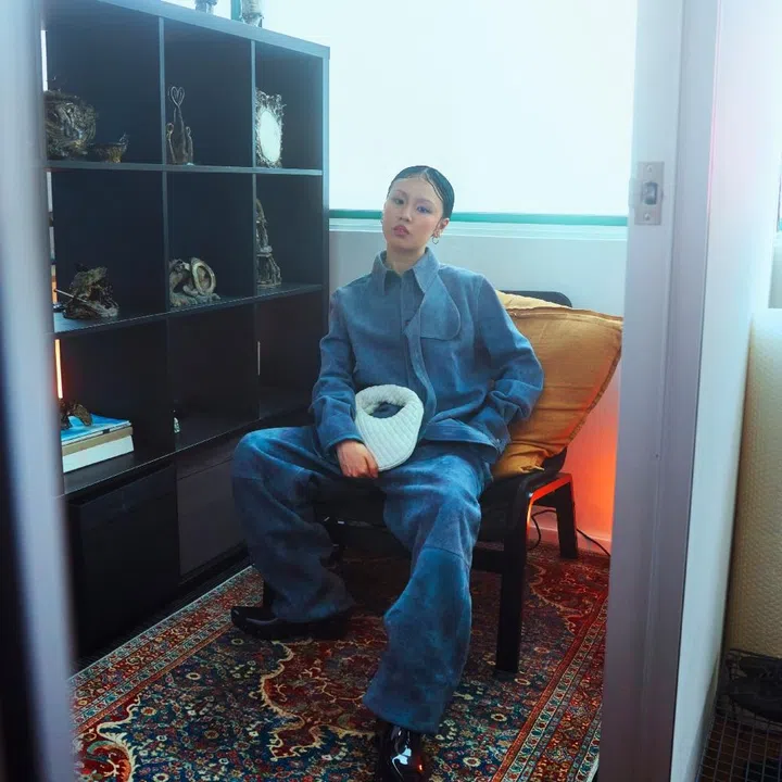 Sculptor Hilary Yeo in Bottega Veneta blue suede and white Baby Veneta clutch for F ZINE.