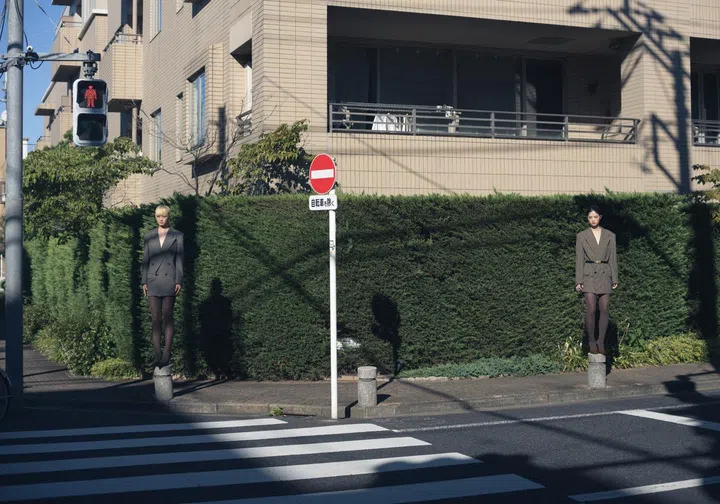 Japanese photographer Osamu Yokonami models standing in neighbourhood
