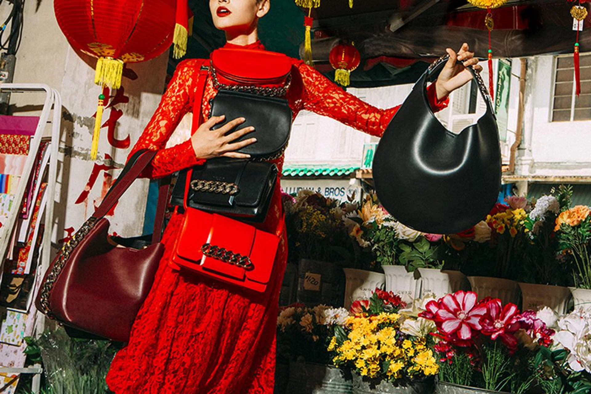 On right arm: Infinity bucket bags. On left arm: Infinity hobo bag. Other bags (from top): Infinity saddle and flap bags. All in leather. Lace bodysuit and matching skirt. All Givenchy